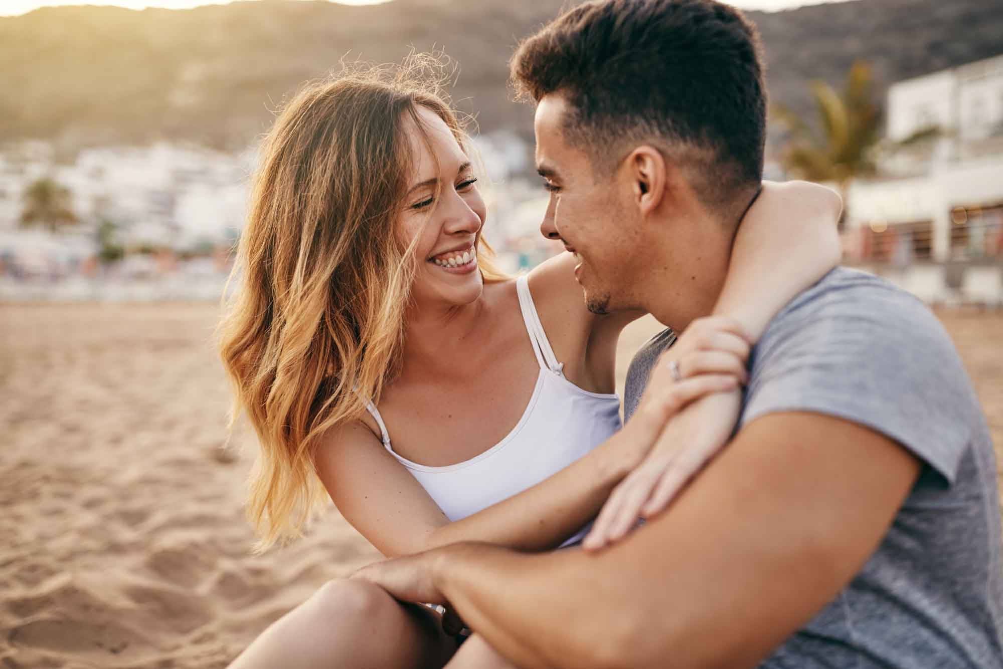 happy couple on beach after getting out of the cycle, EFT