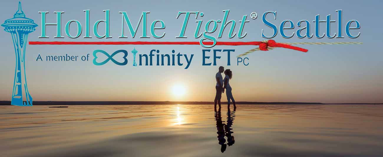 Couple kiss at sunset on beach with Hold Me Tight Seattle logo